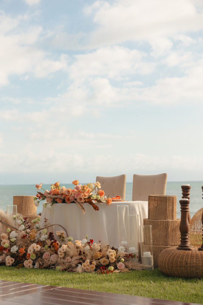 Destination wedding photographer capturing the essence of luxury details amidst a tropical sunset- this beachfront Hawaii wedding decor radiates with romance.