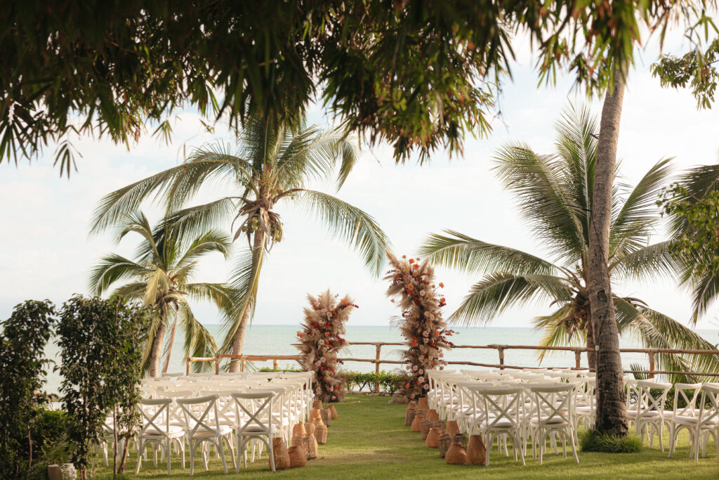 Destination wedding photographer capturing the essence of luxury details amidst a tropical sunset- this beachfront Hawaii wedding decor radiates with romance.