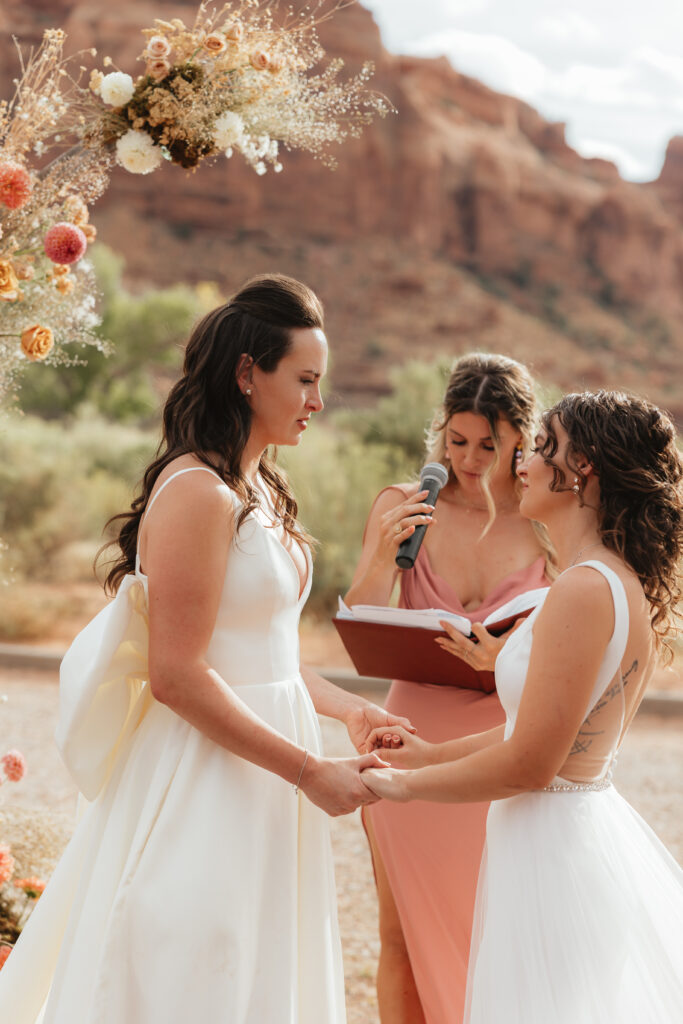  Utah Adventure Wedding celebrated at Under Canvas Moab, Red Earth Venue, and Arches National Park. Beautiful brides & desert wedding inspo!