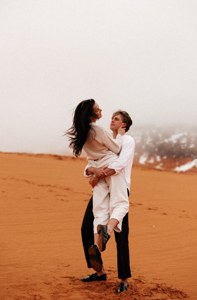 Documentary Couples Adventure on the Coral Pink Sand Dunes of Kanab, Utah. Explore with us in Cave Lakes Canyon Ranch in southern Utah for this adventurous engagement session with Jessie Lyn Photography!