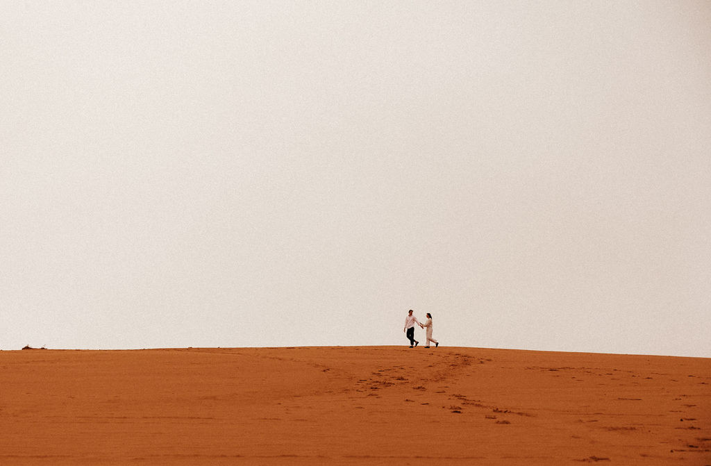Documentary Couples Adventure on the Coral Pink Sand Dunes of Kanab, Utah. Explore with us in Cave Lakes Canyon Ranch in southern Utah for this adventurous engagement session with Jessie Lyn Photography!